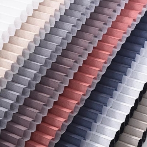 Honeycomb cellular blinds fabric samples showing multiple color options from beige to pink, grey and navy blue