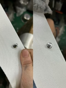Comparison of stainless steel and aluminum fasteners on curtain tape - stainless steel nail on the left shows superior durability and corrosion resistance compared to aluminum