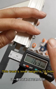 Measuring aluminum curtain track inner height at 16.3mm with digital caliper