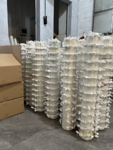 Industrial curtain runners packed in cylinders using our proprietary packing method - an innovative production solution by China's leading curtain runner manufacturer for preventing line entanglement during packaging.