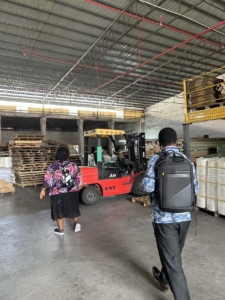 Rebecca and David inspecting curtain tracks at the warehouse with R&C staff