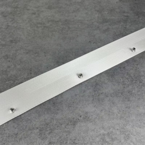 Clean product shot of white ripple fold curtain tape with evenly spaced metal grommets on gray background
