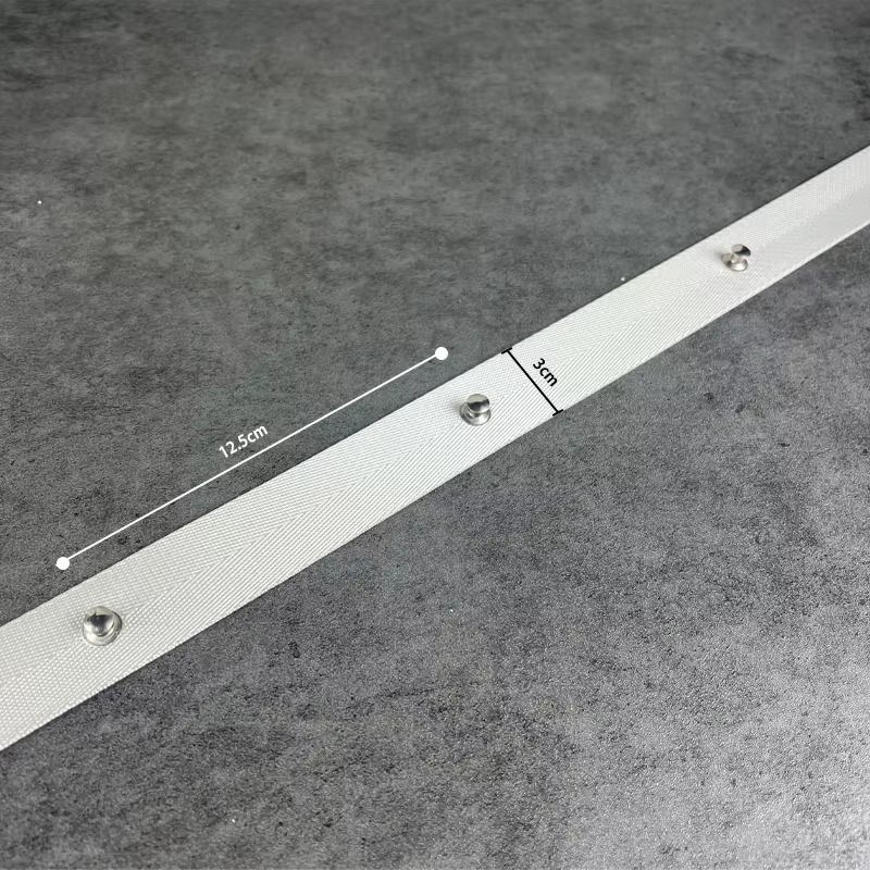 Close-up of white ripple fold curtain tape with dimension markers indicating 3cm width and 12.5cm grommet spacing