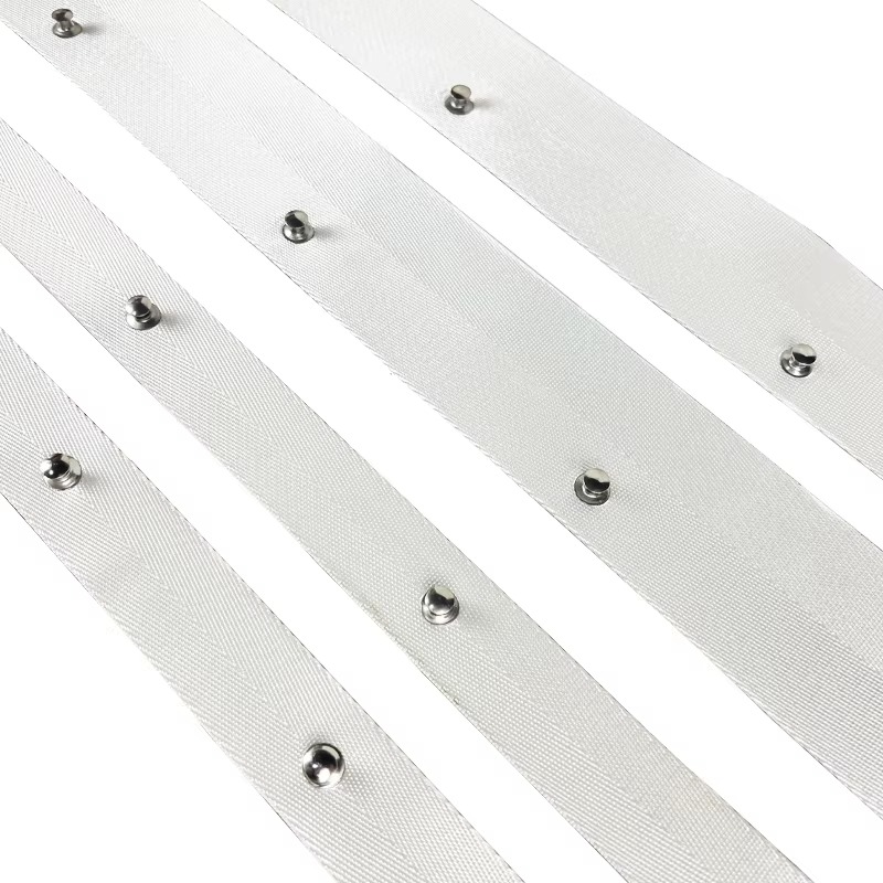 Multiple white ripple fold curtain tape strips with metal grommets arranged diagonally on white background